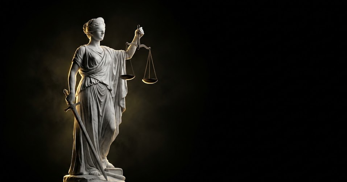 A marble statue of Themis, blindfolded and holding scales, lit by a single hard gold rim light against pure void black