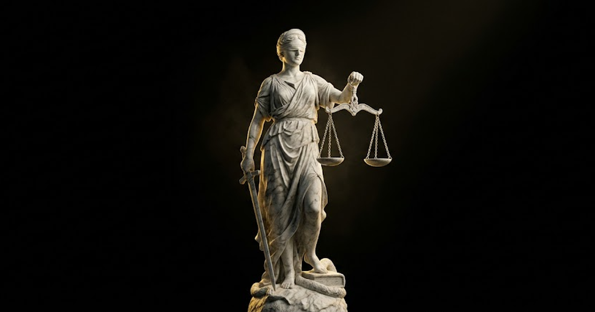 Colossal blindfolded marble statue of Themis holding level scales in darkness lit by gold light