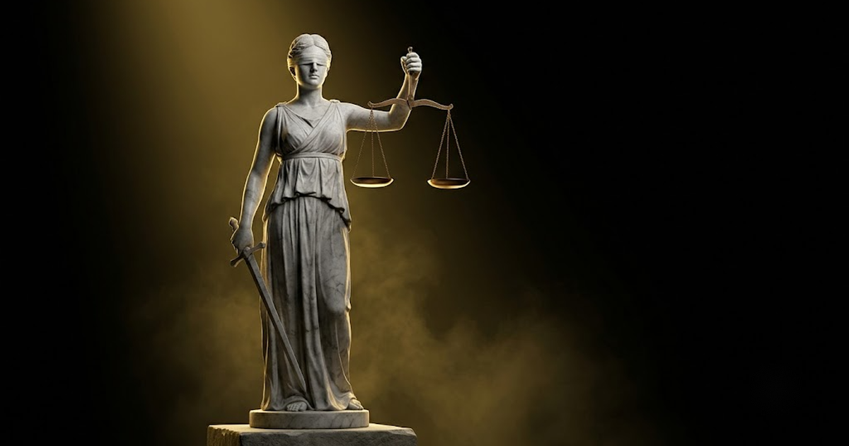 A colossal marble figure of Themis holding balanced scales in shadow, lit by gold light against a black background