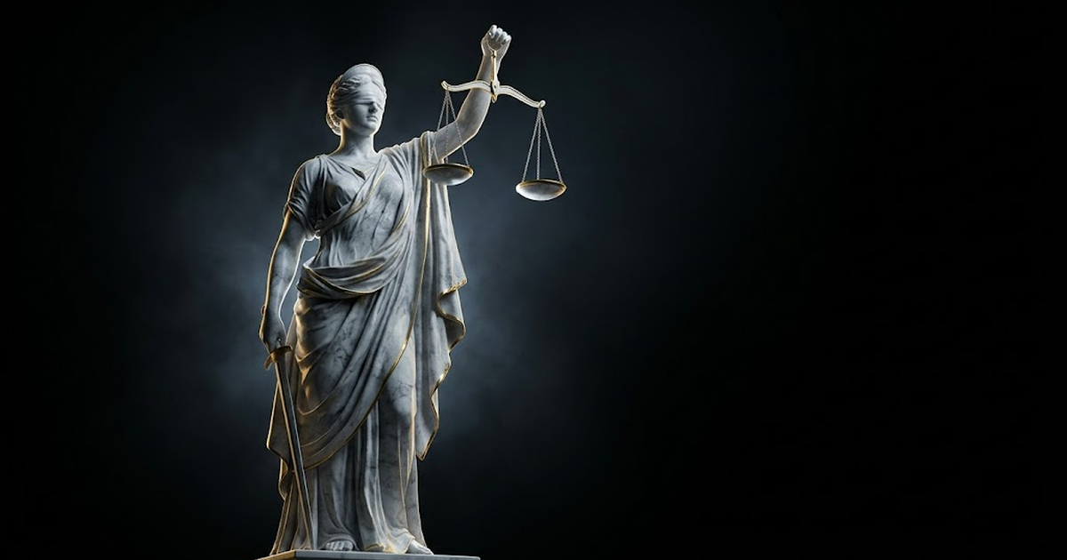 A colossal marble statue of Themis blindfolded and holding balanced scales, lit by gold light against a black background